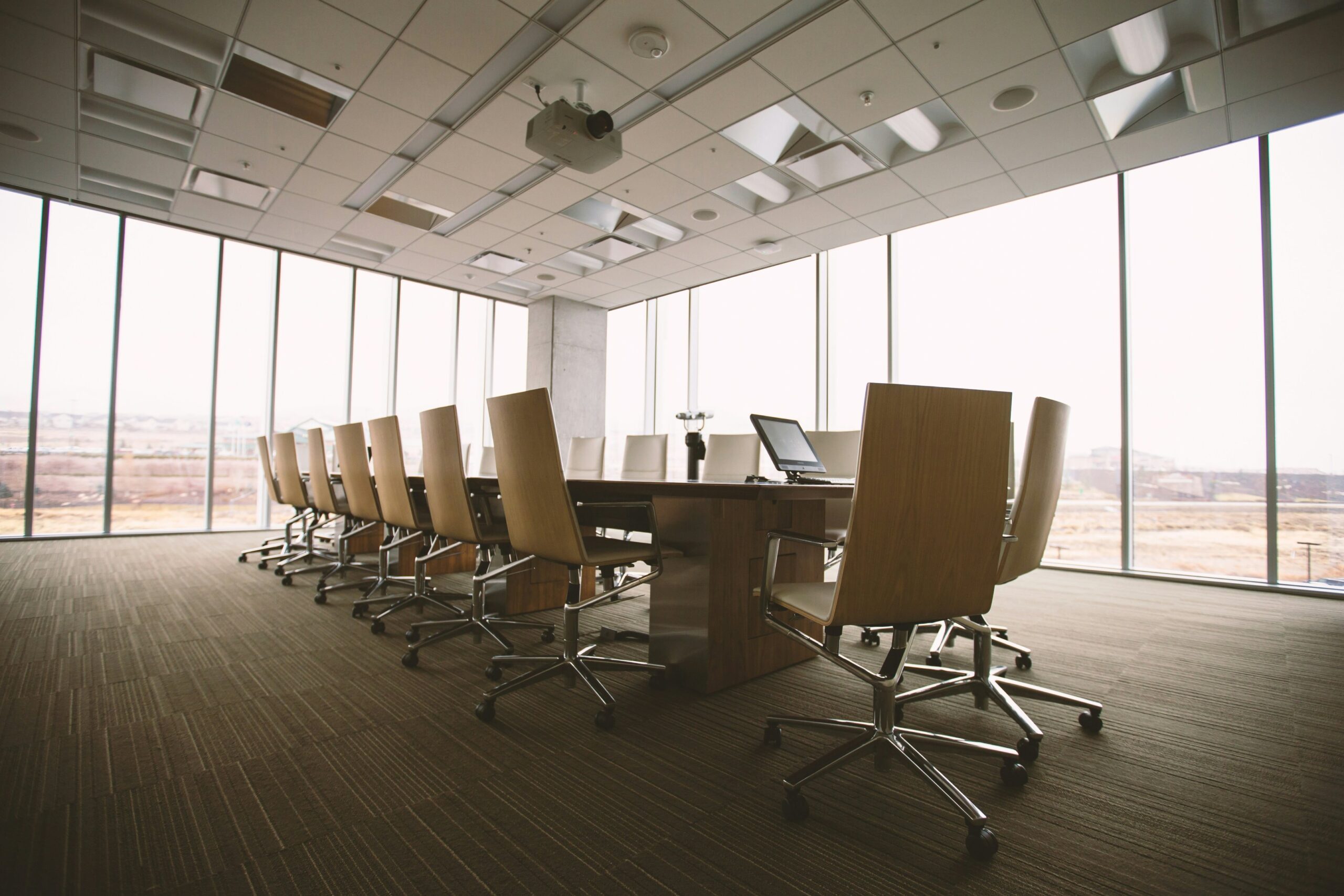 a conference room with a laptop and a laptop