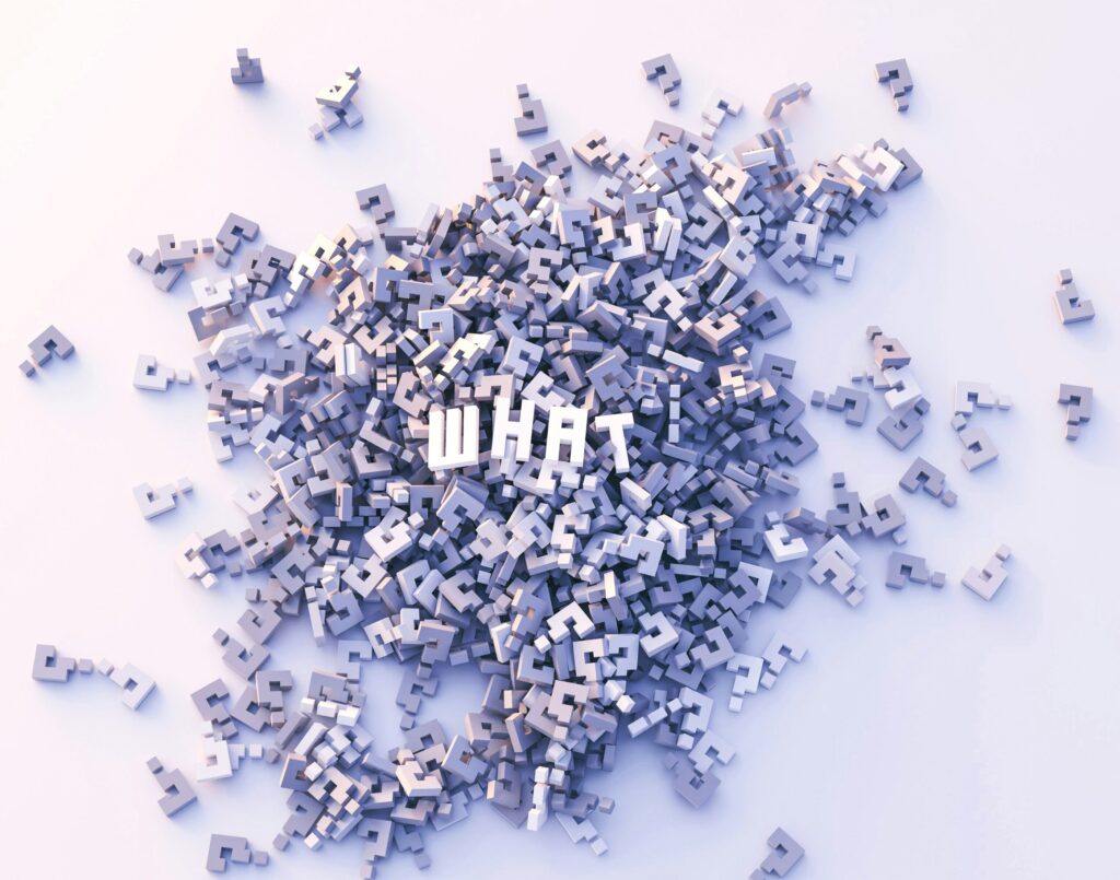 A scattered arrangement of question mark symbols with the word "WHAT" prominently displayed in the center.