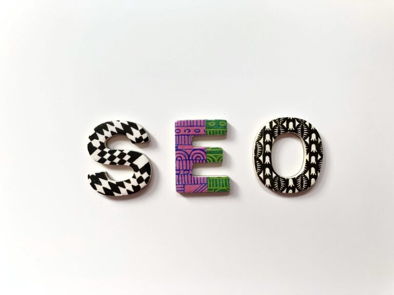 Colorful letters spelling "SEO" arranged on a plain background.